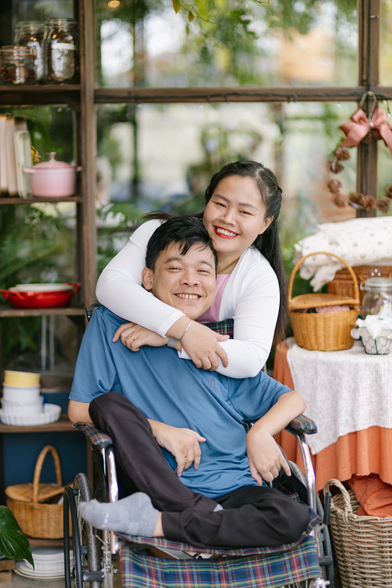 Nguyễn Trung Hậu and his wife sharing a warm moment in a lived-in family space
